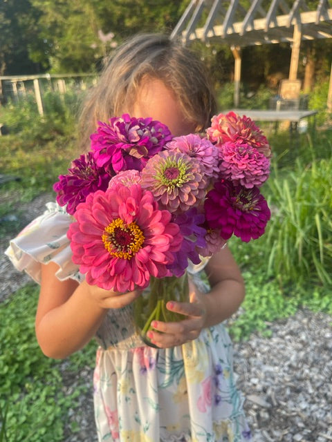 Little girl with Zinnias - Bits & Blooms Flower Farm